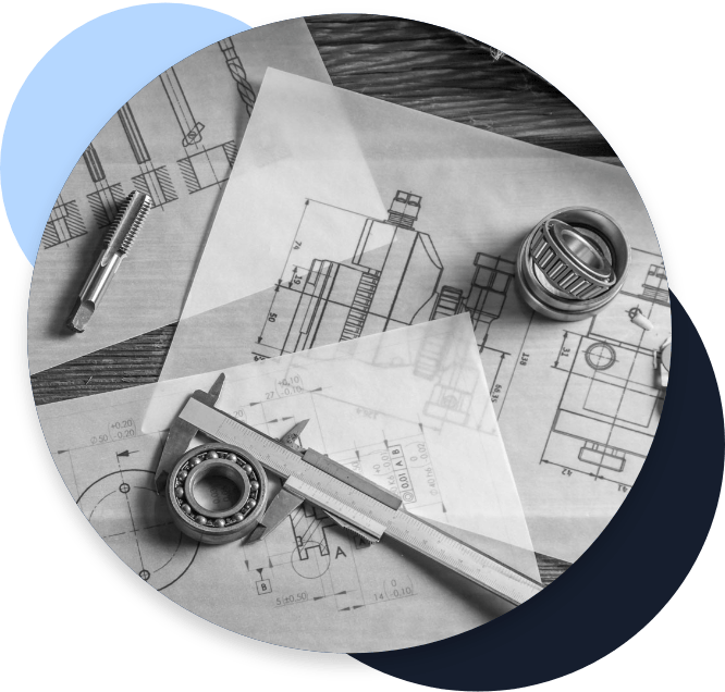 Engineering schematics and various tools on a table