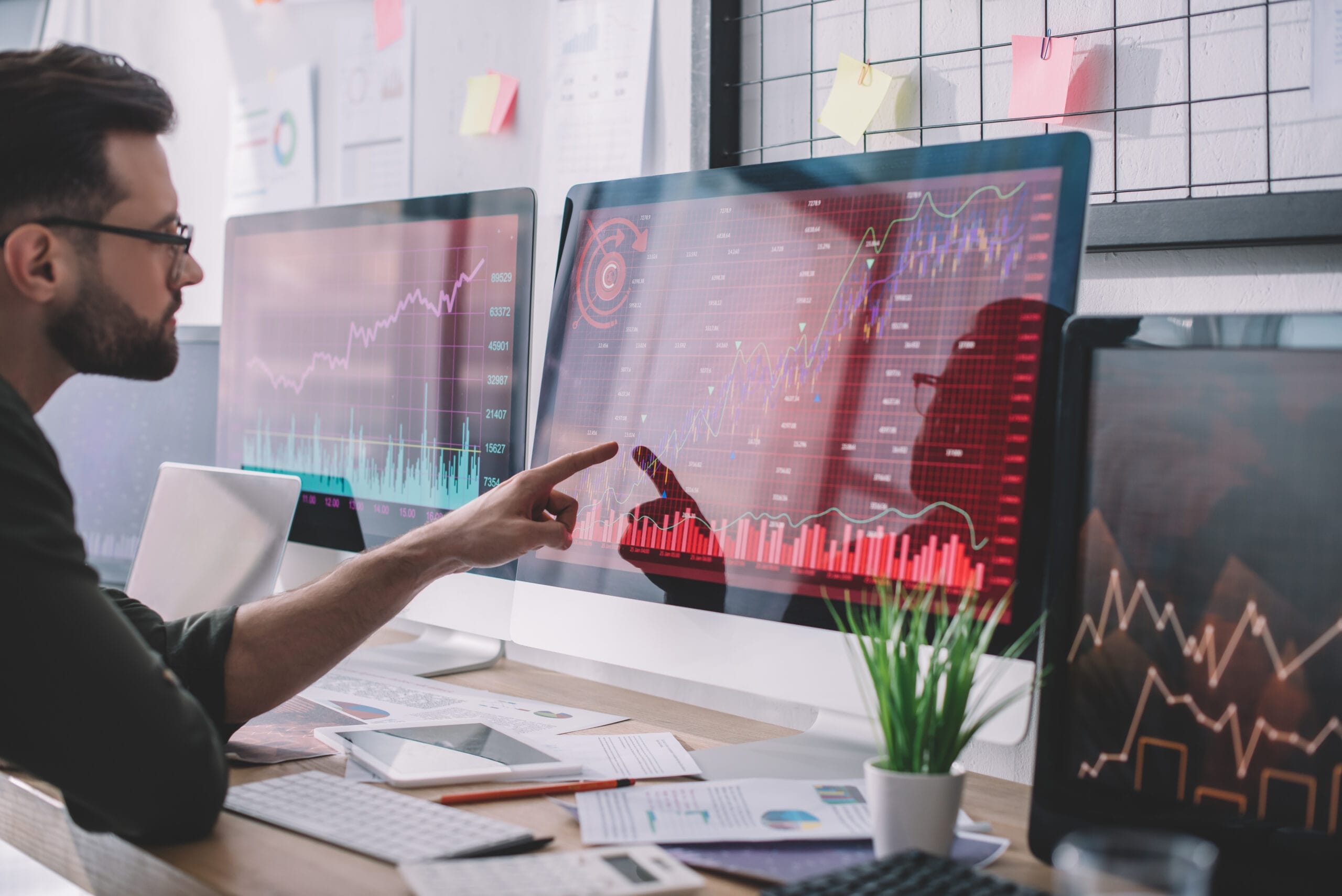 Side,View,Of,Data,Analyst,Pointing,With,Finger,At,Charts